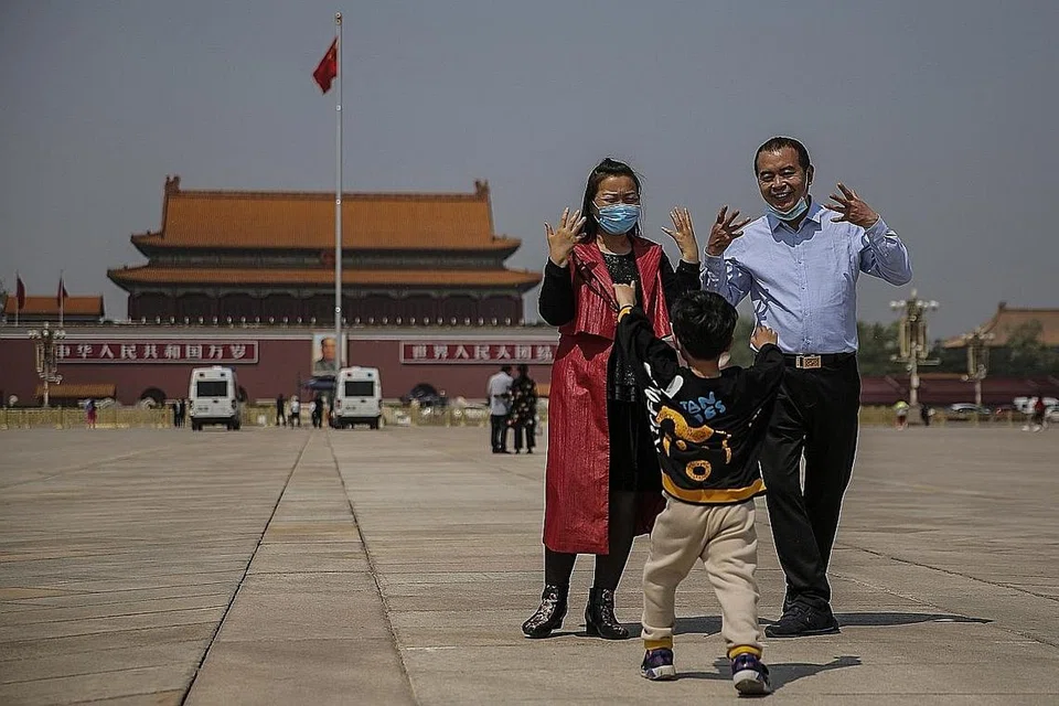 LEBIH SANTAI: Sebilangan pengunjung di kawasan Lapangan Tiananmen di Beijing dilihat mengambil gambar dengan memakai pelitup. - Foto EPA-EFE 