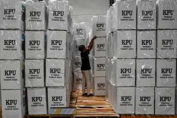 Seorang pekerja memeriksa peti undi di Surabaya untuk pilihan raya umum pada 14 Februari. 