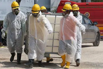 OPERASI PEMBERSIHAN: Beberapa kakitangan kecemasan memakai pakaian khas dilihat bersedia melakukan operasi pembersihan Sungai Kim Kim di Pasir Gudang. - Foto AFP