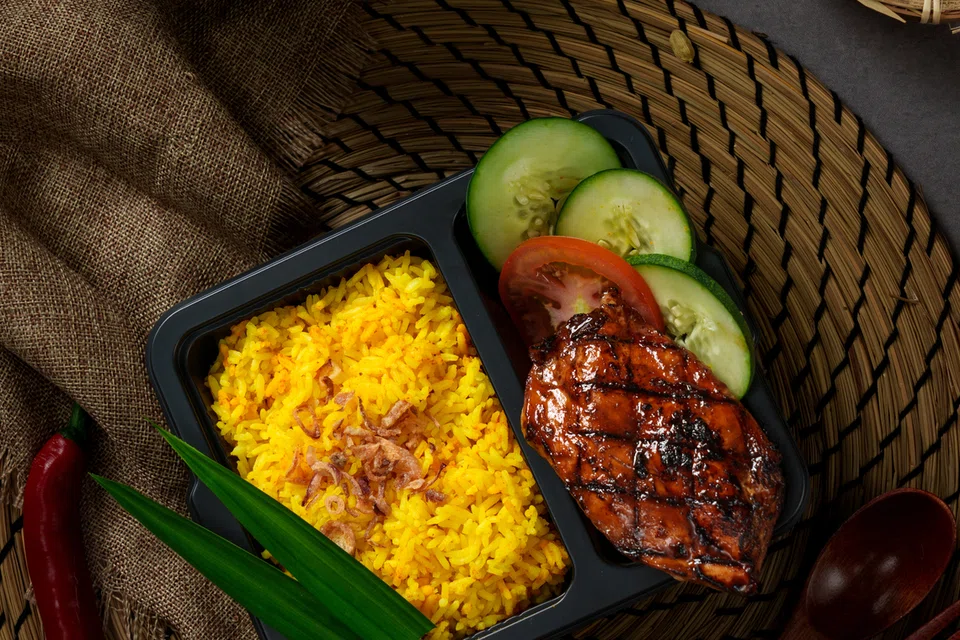 Hidangan Indonesian Herb-Grilled Chicken with Golden Turmeric Rice.
