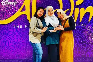 AMATI NILAI KEMANUSIAAN: Cik Siti Aidah Abdul Kalil (tengah) bersama anaknya, Cik Aryna Khalishah Jumari (kiri) dan Cik Aryna Dayanna, menghargai peluang sulung menonton muzikal Broadway Disney, Aladdin kerana senangi set gah, babak permaidani terbang dan unsur kemanusiaan seperti berani mengharungi cabaran. - Foto ihsan SITI AIDAH ABDUL KALIL