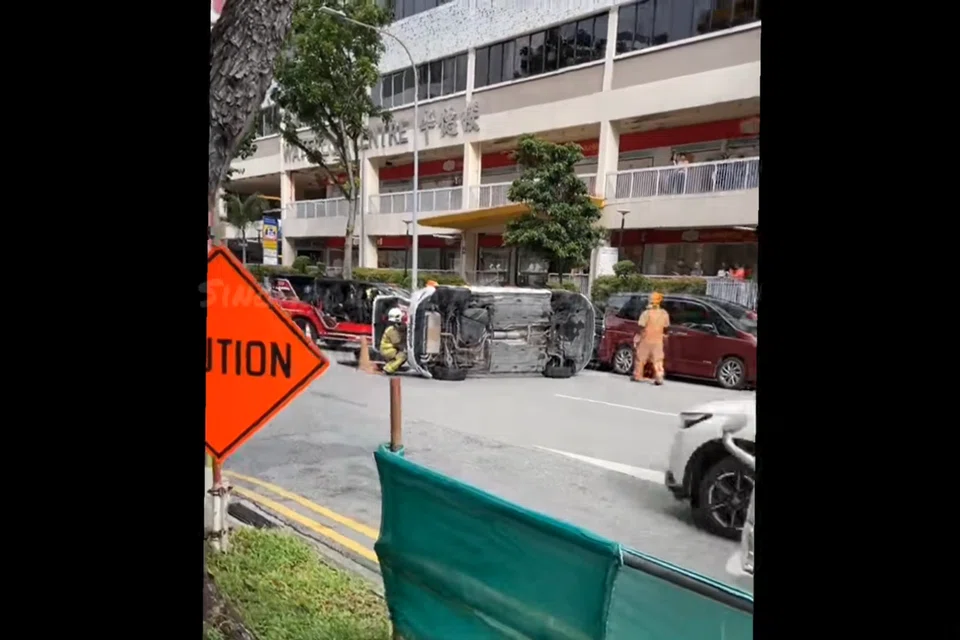 Kereta putih berjenama Volkswagen terbalik di tengah jalan raya di luar pusat beli-belah Waterloo Centre pada 19 November selepas ia merempuh satu lagi kereta yang terletak di sana.