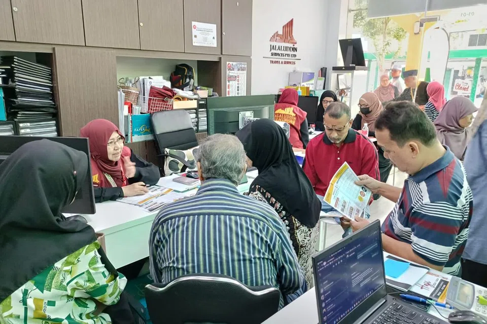 RUMAH TERBUKA HAJI: Pegawai dan kakitangan dari Jalaluddin Travel & Services Pte Ltd sibuk melayan bakal jemaah haji yang datang ke pejabat mereka pada 3 Disember bagi membuat pertanyaan serta pendaftaran untuk menunaikan ibadah haji pada 2024. 