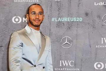 ANUGERAH: Lewis Hamilton (atas) dan bintang bola sepak Lionel Messi berkongsi anugerah Atlit Terbaik Tahunan Laureus dalam majlis berlangsung awal pagi semalam di Berlin. - Foto EPA-EFE, Reuters