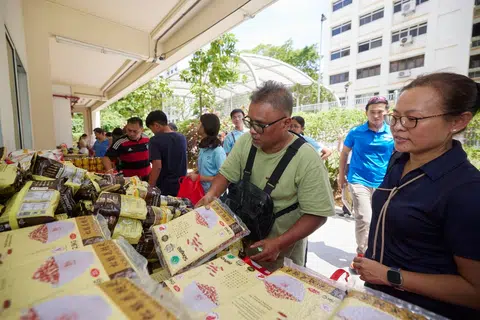 Orang ramai dan keluarga berhimpun di Kelab Masyarakat Hong Kah North bagi menerima pek barangan makanan dan dapur sihat dalam satu sesi pengagihan anjuran Lembaga Penggalakan Kesihatan (HPB) dan rakan masyarakat Jaga Kesihatan, Jaga Ummah (JKJU).
