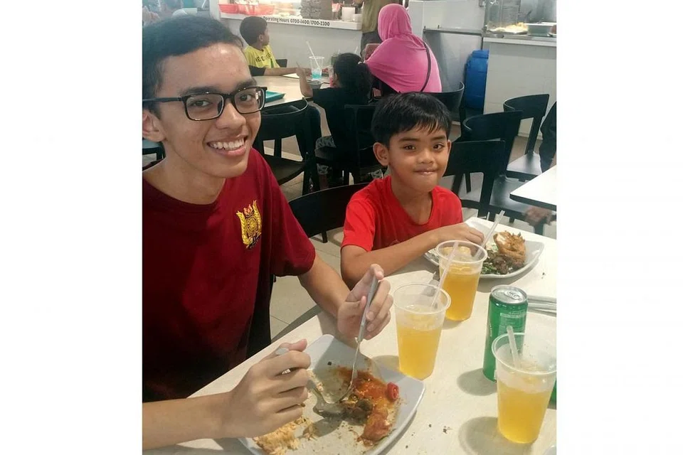 SELESA: Muhammad Mustaghfir (kiri) sering menjamu selera di pusat penjaja Bukit Panjang kerana ia bersih dan tidak lecak. Bersamanya ialah adik bongsunya, Muhammad Mustaufiq.