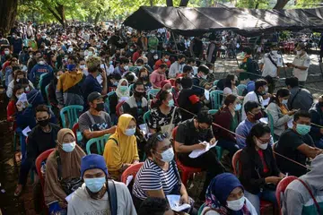 Orang ramai beratur untuk mendaftar mendapatkan vaksin AstraZeneca Covid-19 di Bali, Indonesia. - FOTO AFP
