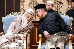 TUNGGAK SOKONGAN: Datuk Seri Anwar berkongsi detik bersejarah diangkat sebagai Perdana Menteri Malaysia ke-10 dengan isterinya, Dr Wan Azizah Wan Ismail, yang keluar dari balik tabir untuk meneruskan reformasi sepanjang beliau dipenjara. - Foto REUTERS 