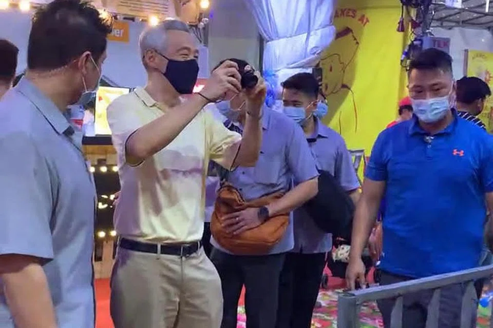 KUNJUNGI BAZAR: PM Lee yang mengunjungi bazar Geylang Serai malam Isnin telah mengambil gambar gerai selain bergambar dengan pengunjung dan pegerai. - Foto-foto FACEBOOK SYAH IBRAHIM
