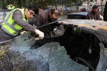 SERANGAN DRON: Anggota pertahanan awam yang bersekutu dengan Hezbollah  memeriksa kereta yang rosak susulan daripada apa yang dikatakan sumber keselamatan sebagai serangan dron Israel di pinggir bandar selatan Beirut di Dahiyeh, Lebanon pada 3 Januari 2024.