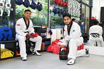 Raja Arshad Raja Mahmod (kanan) bersama abangnya, Raja Zulfadli Raja Mahmod, di Swiftkicks Taekwondo di Hougang. 
