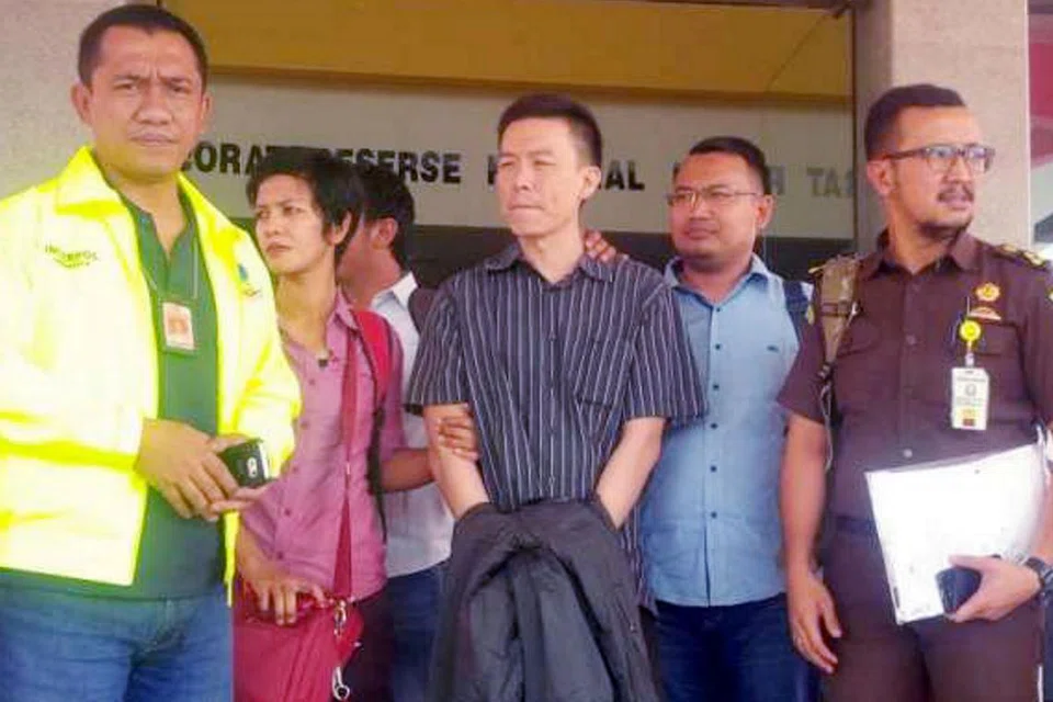 DIDAKWA DI AMERIKA: Warga Singapura Lim Yong Nam (baju berjalur biru) meninggalkan Batam sebelum dihantar ke Amerika untuk menghadapi pendakwaan. - Foto fail