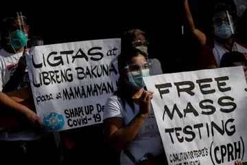 KEPRIHATINAN NEGARA: Pekerja kesihatan di Filipina melaungkan ujian percuma beramai-ramai dan vaksin percuma menyusuli penularan wabak Covid-19 di Quezon City, Metro Manila. - Foto REUTERS 