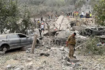 Anggota tentera Lebanon memeriksa kerosakan akibat serangan udara Israel ke atas Aitou, kawasan yang majoriti penduduknya beragama Kristian di utara Lebanon, pada 14 Oktober.