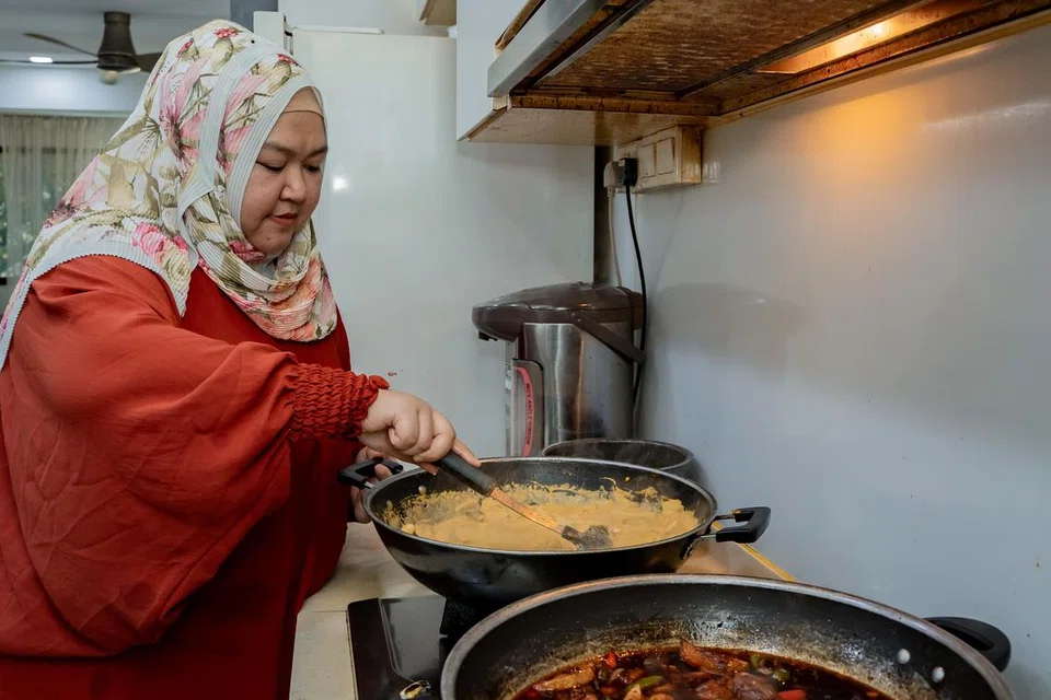 Cik Sriwayuni Rahim sedang memasak lauk lemak nangka daging dan ayam kicap, resipi yang diturunkan oleh ibunya, Cik Mariam Zakariya. 
