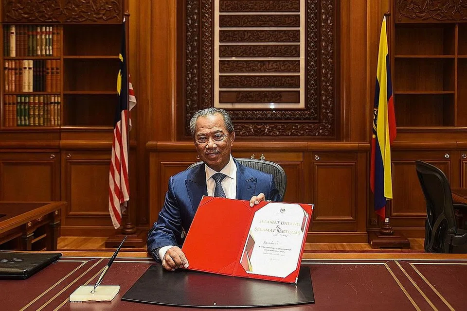 HARI PERTAMA: Tan Sri Muhyiddin memulakan tugas sebagai Perdana Menteri Malaysia kelapan di Bangunan Perdana Putra, Putrajaya semalam. - Foto AFP