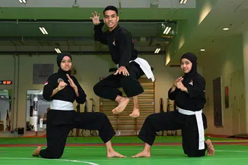 TUMPAH KUAH KE NASI JUA: Bapa mereka, yang pernah bergiat dalam silat, menjadi pengaruh besar untuk (dari kiri) Tuffah, Isqandar dan Syaza mendalami dan mencapai kecemerlangan dalam sukan itu. - Foto BM oleh KHALID BABA