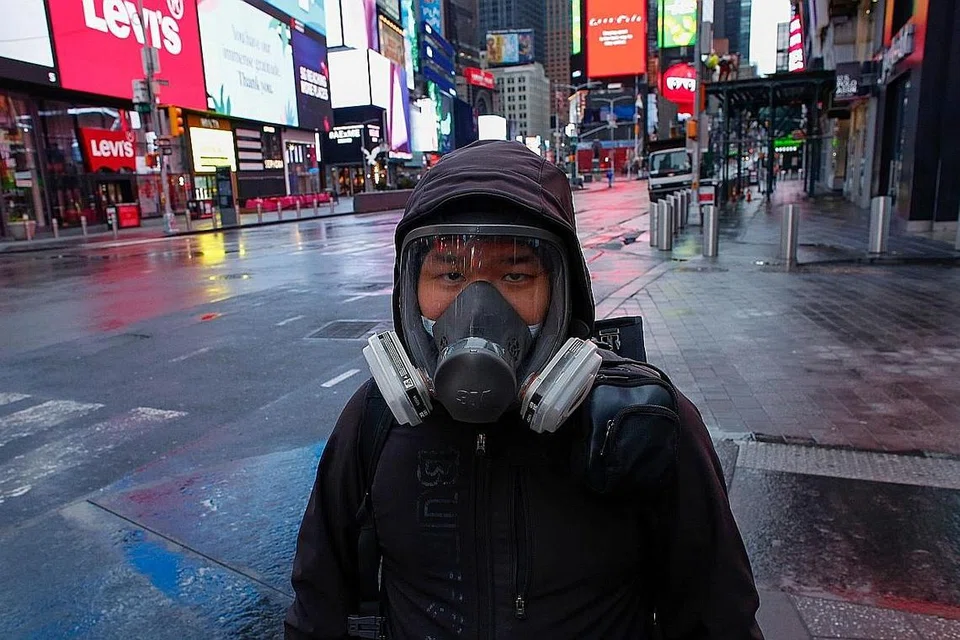 SUNYI SEPI: (Atas) Seorang lelaki memakai pelitup di kawasan Times Square yang kosong di bandar New York, Amerika Syarikat. - Foto AFP, EPA-EFE 