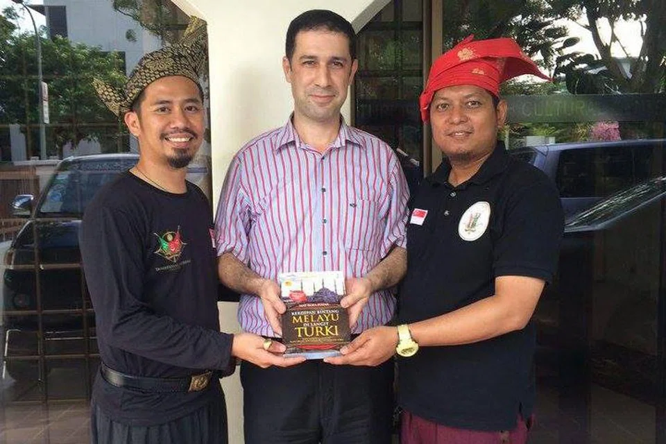MEMPERERAT HUBUNGAN KEBUDAYAAN: Penulis (kanan) dan Encik Mohammad Alfyan Ariff Bahari, pengasas Traditional Archers Singapore (kiri), menghadiahkan buku Kerdipan Bintang Melayu Di Langit Turki tulisan Profesor Mat Rofa Ismail kepada Encik Necmettin Eskici, Pengarah Pusat Kebudayaan Turkey Singapura, dalam satu kunjungan ke pusat itu baru-baru ini. - Foto ihsan USTAZ FACHRUDDIN DZAKI MOHAMED