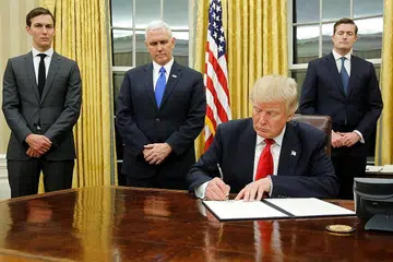 SEGERA BERTUGAS: Encik Donald Trump (duduk) menandatangi arahan eksekutifnya yang pertama di Pejabat Oval semalam dengan diperhatikan (dari kiri) Penasihat Kanan, Encik Jared Kushner; Naib Presiden Mike Pence; dan Setiausaha Kakitangan, Encik Rob Porter. - Foto REUTERS
