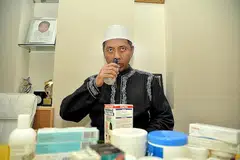 TARIK NAFAS LEGA: Ustaz Mohamad Hamzah, yang menghidapi sinus kronik, semput dan penyakit kulit psoriasis, berasa lega mendapat rujukan untuk memperolehi Bantuan Kewangan Asatizah (AFA) kendalian Persatuan Ulama dan Guru-Guru Agama Islam Singapura (Pergas) bagi mengurangkan beban kewangan rawatan kesihatan serta kehidupan beliau. - Foto M.O. SALLEH