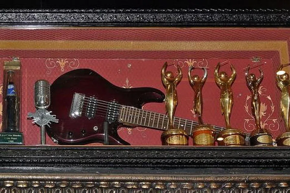 PENCAPAIAN DIKENANG: Gitar berharga dan anugerah yang dimenangi Ahmad Dhani dibingkai dan dipamer buat tetamu. 