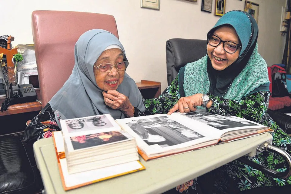 SUSURI LORONG KENANGAN BERSAMA: Anak ketiga dalam keluarga Allahyarham Pendeta Dr Muhammad Ariff Ahmad, Cik Shahrulbariah (kanan), meneliti buku dan gambar lama bersama ibu, Cik Sarinah Hanif. Mereka ditemui di rumah Allahyarham dalam kawasan Nemesu Avenue, berdekatan Upper Thomson Road, baru-baru ini. Semua bahan yang dipaparkan pada halaman ini tidak dimuatkan dalam hab kajian MAS RRH@LIBRIS. Gambar dan tulisan berikut dikeluarkan khas buat tatapan pembaca 'Berita Minggu' sahaja. - Foto BM oleh CHONG JUN LIANG