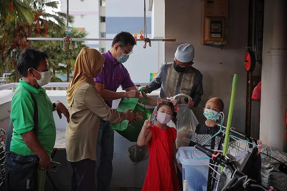 SERTAIKAN MAJLIS BUKA PUASA: Relawan menghantar bento makanan bagi keluarga Abu Talib Jaffar yang turut serta dalam majlis berbuka puasa. - Foto BH oleh JASON QUAH 