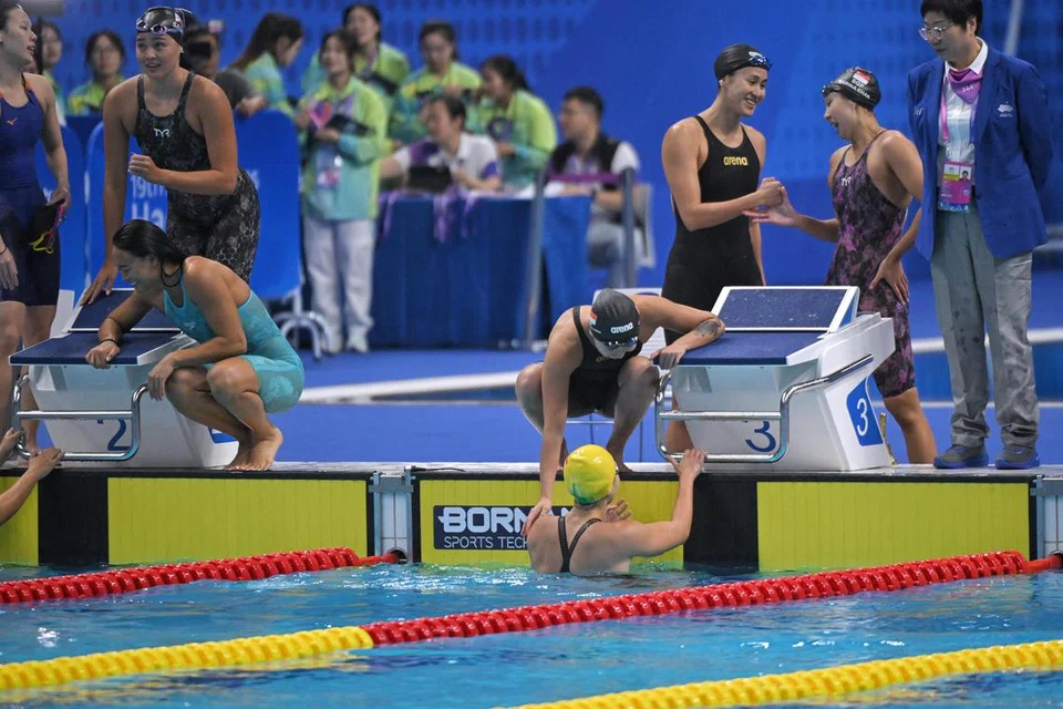 NYARIS MENANG PINGAT: Pasukan perenang Singapura (kanan) hampir berjaya memenangi pingat pertama mereka dalam acara 4x100 meter, tetapi akhirnya terlepas dan mendapat kedudukan keempat, di belakang China, Jepun dan Hong Kong.