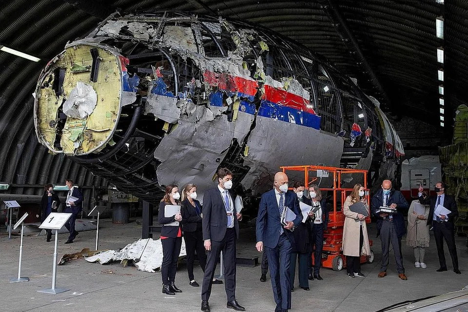 PERIKSA PESAWAT: Gambar yang diambil pada 26 Mei ini menunjukkan Hakim Hendrik Steenhuis (tengah), disertai hakim dan peguam lain sedang melihat bangkai pesawat Malaysia Airlines MH17 yang dibina semula, di sebuah pangkalan udara. - Foto AFP
