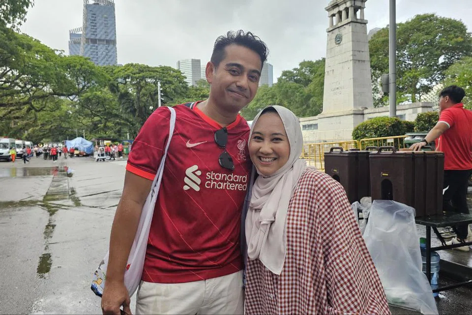Cik Nur Diana Ishak dan suami, Encik Muhamad Fadhli Rosli, kedua-duanya berusia 35 tahun, meredah hujan lebat dan tiba seawal 4 petang untuk mendapatkan tempat duduk baik di Padang.