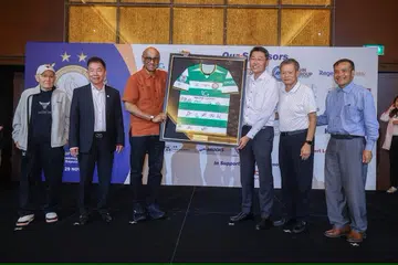 Penasihat Geylang International, Encik Ben Teng (tiga dari kanan), menyampaikan jersi kepada Presiden Tharman Shanmugaratnam (tiga dari kiri) di majlis jamuan malam sempena jubli emas kelab bola sepak itu bersama (dari kiri) pengasas, Encik Colin Ng; pengerusi, Encik Thomas Gay; serta mantan pengerusi, Encik Patrick Ang dan Encik Leong Kok Fann.