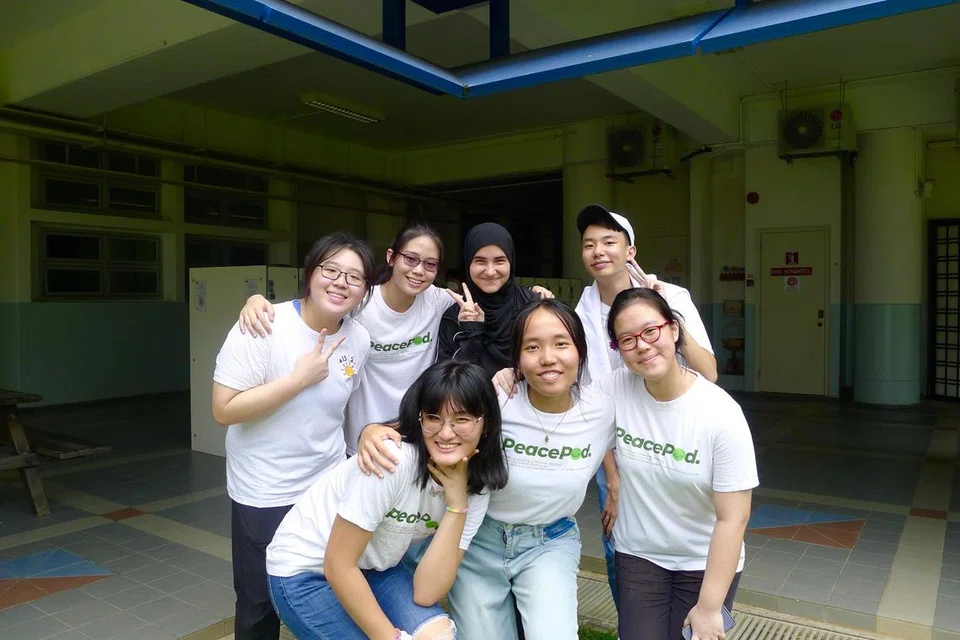 Cik Judy Chua (barisan hadapan, tengah) dan Cik Salwa Khan (barisan belakang, tiga dari kiri) sentiasa bersemangat dalam meningkatkan kesedaran kesihatan mental kepada orang ramai menerusi PeacePod.