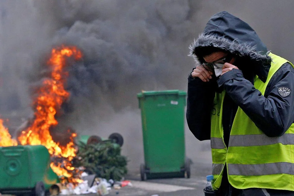 SISA-SISA RUSUHAN: Kereta yang hanya tinggal bangkai setelah dibakar semasa rusuhan penunjuk perasaan 'ves kuning' (gambar atas) kelmarin dialihkan ke atas trak tunda semasa operasi pembersihan di Paris kelmarin. Penunjuk perasaan 'ves kuning' itu memprotes kos kehidupan yang kian meningkat di negara itu sambil menuntut peletakan jawatan Presiden Emmanuel Macron. - Foto REUTERS