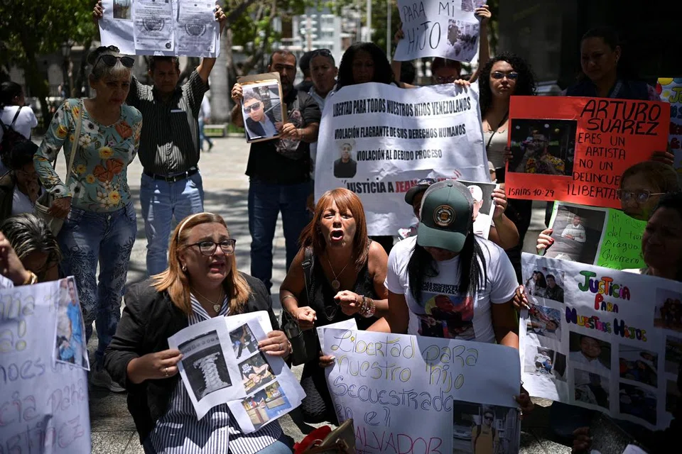Ahli keluarga warga Venezuela yang kini ditahan di sebuah penjara dengan kawalan keselamatan tinggi di El Salvador selepas dihantar pulang dari Amerika Syarikat, memegang plakad dan gambar insan tersayang semasa tunjuk perasaan bagi menuntut pembebasan mereka, di Caracas, Venezuela, 24 Mac 2025.