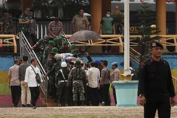 DITIKAM: Polis dan tentera Indonesia membawa Ketua Menteri Keselamatan Indonesia Wiranto ke helikopter selepas beliau ditikam di Pandeglang, Banten semalam. - Foto AFP