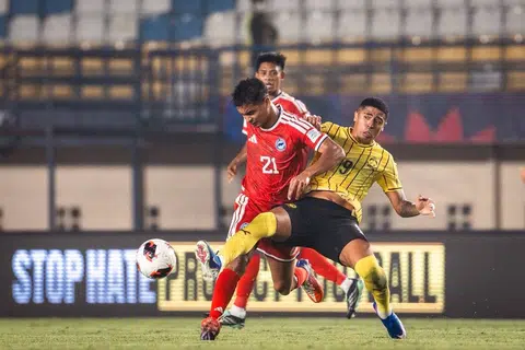 Pasukan Singa (jersi merah) cuba mengatasi asakan pemain Harimau Malaya ketika perlawanan Kumpulan A Piala Asean FIFA. Singa akhirnya ditundukkan 6-0. Keputusan itu bermakna Singa tersingkir daripada kejohanan tersebut