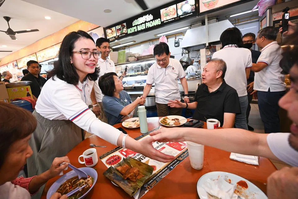 Calon berpotensi Parti Tindakan Rakyat (PAP) untuk Pilihan Raya Umum (GE) 2025, Cik Hazlina Abdul Halim (kiri), beramah mesra dengan penduduk GRC East Coast semasa satu lawatan ke kawasan Joo Chiat pada 5 April.