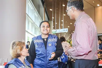 MENCEGAH JENAYAH: Anggota Parlimen (AP) Bukit Batok, Encik Murali Pillai, yang juga timbalan pengerusi Jawatakuasa Parlimen Pemerintah (Ehwal Dalam Negeri merangkap Undang- Undang) berinteraksi dengan Cik Nur Arfa Muhammad Rahmat (tengah) mengenai tugasnya sebagai relawan Skim Rakyat Sedang Meronda (COP) di Sembawang. - Foto CMG