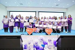 Anggota Parlimen (AP) GRC Sembawang, Cik Mariam Jaafar, (12 dari kiri) dan Setiausaha Tetap Kementerian Kebudayaan, Masyarakat dan Belia (MCCY), Cik Teoh Tsin Woon (10 dari kiri) bergambar bersama sukarelawan pusat penuaan aktif Blossom Seeds semasa acara The Purple Party pada 14 Disember.