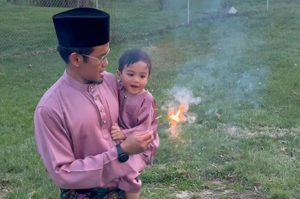 Encik Hilwan dan anaknya, Muhammad Akmal Muhammad Hilwan, ketika bermain mercun.