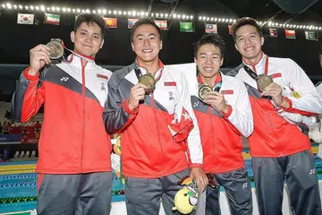PINGAT PERTAMA SINGAPURA: (Dari kiri) Joseph Schooling, Quah Zheng Wen, Jonathan Tan dan Danny Yeo memastikan Singapura meraih pingat gangsa dalam perlumbaan 4x200m relay gaya bebas, yang pertama buat Singapura dalam temasya Sukan Asia Indonesia ini. - Foto BH oleh KEVIN LIM