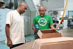 KELENGKAPAN BAGI PENGURUSAN JENAZAH: Encik Iskandar (kiri) melihat kakitangan, Encik Mohd Ramlee Mohd Ali, membuat papan long di kilang Singapore Muslim Casket & Marble Contractor yang terletak di Geylang Bahru. Syarikat itu dipercayai satu-satunya syarikat pengurusan jenazah Islam yang mempunyai kilang kecil untuk membuat papan long.