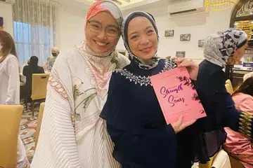 BUKU TERLARIS: Buku hasil tulisan Ustazah Liyana Musfirah (kiri) 'The Spiritual Strength in Our Scars' adalah antara buku yang digemari ramai pengikutnya di seberang Tambak. Bersama beliau pemilik tudung popular Duck, Vivy Yusof. - Foto-foto ihsan USTAZAH LIYANA MUSFIRAH