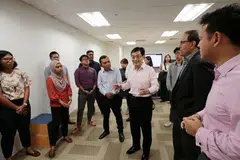 BERAMAH MESRA: Encik Heng Swee Keat (tiga dari kanan) beramah mesra dengan kakitangan BH dalam lawatannya ke bilik berita BH semalam. Beliau ditemani Encik Saat A. Rahman (empat dari kanan), Encik S. Iswaran (dua dari kiri) dan Encik Zaqy Mohamad (kanan). - Foto BH oleh JASON QUAH