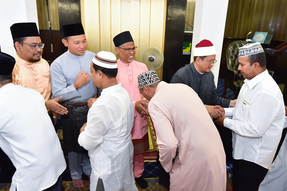 Encik Masagos (baju merah jambu) bersalaman dengan jemaah selepas solat Aidiladha di Masjid Ar-Raudhah pada 11 Ogos. Beliau menggesa masyarakat Melayu / Islam supaya menjiwai sifat keimanan dan pengorbanan bukan sahaja sempena Hari Raya Aidiladha, malah sepanjang tahun. Bersama beliau ialah Dr Fatris (kanan) dan Encik Fahmi (dua dari kiri).