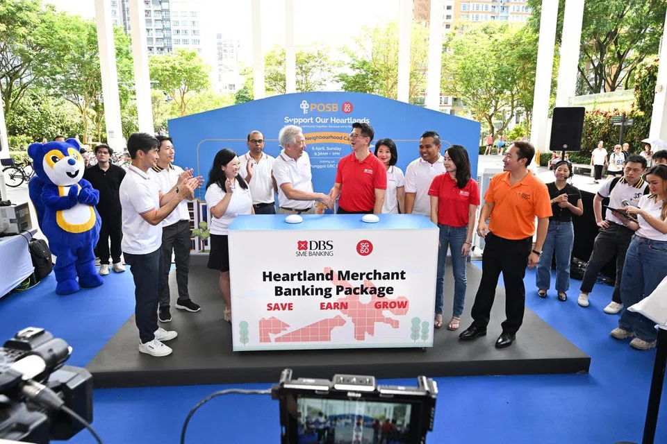 Menteri Kanan, Encik Teo Chee Hean (lima dari kiri), yang melancarkan Pakej Perbankan Peniaga Kawasan Perumahan Awam kendalian DBS Bank, berjabat tangan bersama Ketua Kumpulan, Ketua Singapura, DBS, Encik Lim Him Chuan, pada 6 April. Mereka diapit antara lain bersama Anggota Parlimen (AP) GRC Pasir Ris-Punggol dan SMC Punggol West.