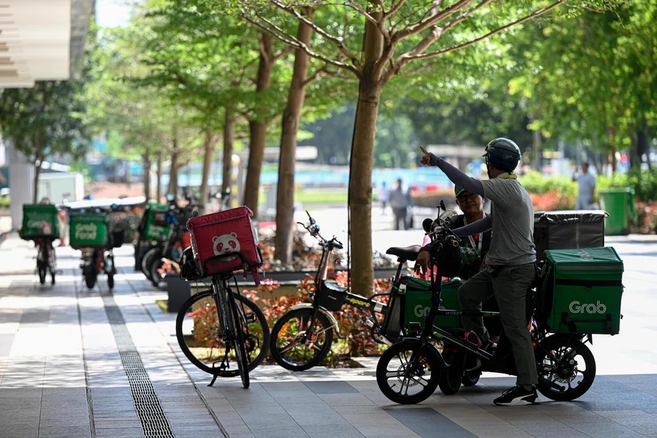Pekerja penghantaran meletakkan kenderaan mereka di luar Paya Lebar Square, menghalang laluan jalan kaki bagi pengunjung ke pusat beli-belah tersebut.