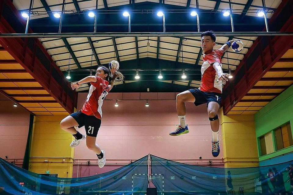 AZAM PERBAIKI PERSEMBAHAN: Pemain wanita pasukan bola baling Singapura Ham Jia Yun dan kapten pasukan lelaki Teo Kee Chong beraksi di Dewan Sukan Hougang pada 19 Disember. - Foto BH oleh KEVIN LIM