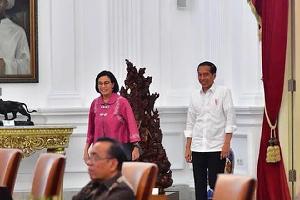 JADI SOROTAN: Menteri Kewangan Indonesia, Cik Seri Mulyani (kiri berdiri) yang mengelak memberi komen terhadap dakwaan yang beliau meletakkan jawatan. Gambar menunjukkan beliau bersama Presiden Joko Widodo pada 19 Januari di Istana Presiden.